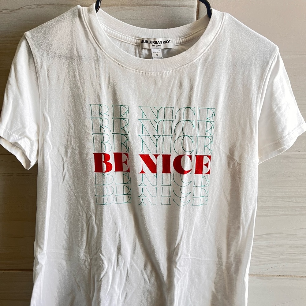 white “be nice” graphic tee